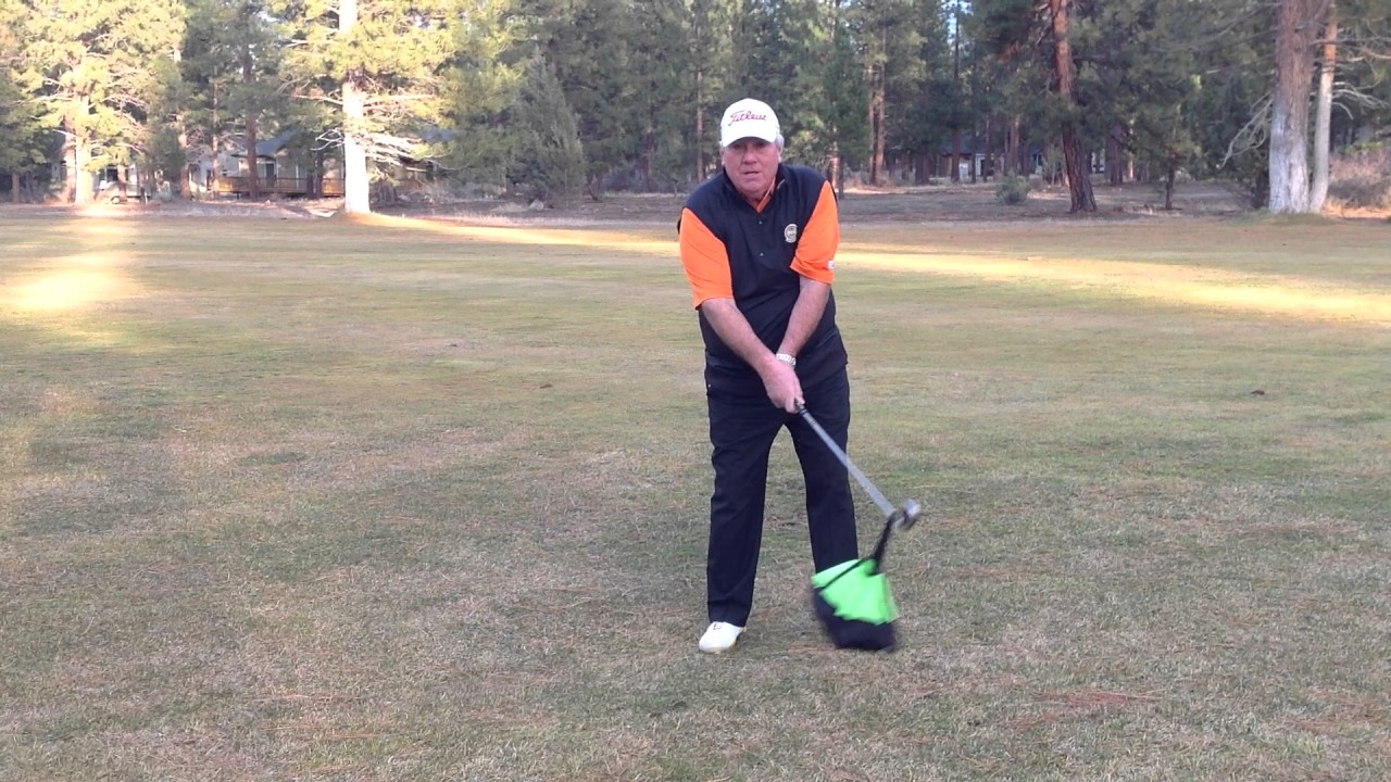 Golfer using the Chute Trainer for golf swing speed training